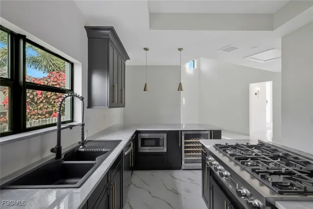 a kitchen that has a sink and a stove