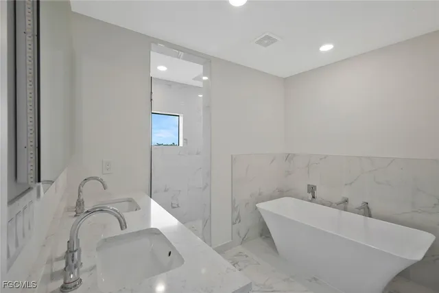 a bathroom with a bathtub and sink