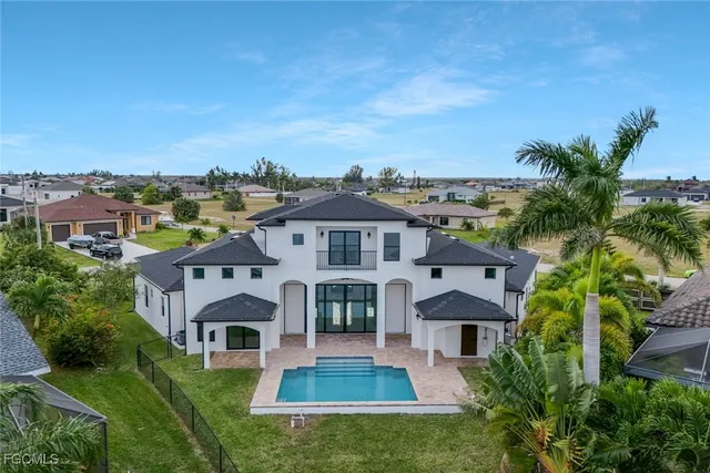 an aerial view of residential houses with yard and ocean view