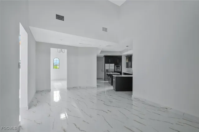 a spacious bedroom with a bed and a large window