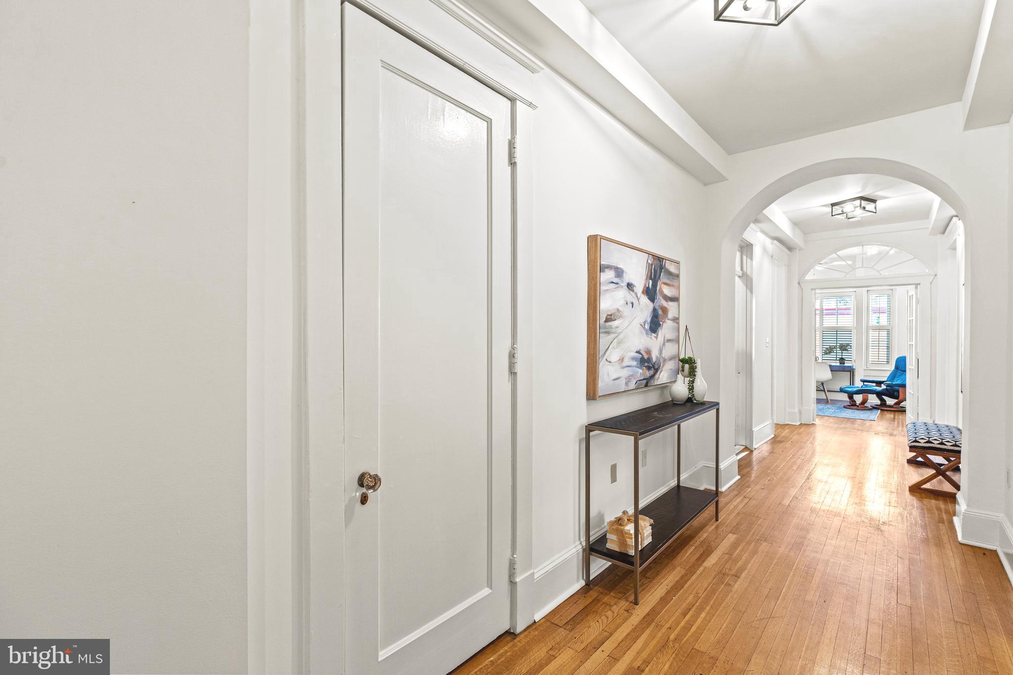 1736 Columbia Road Northwest, Unit 102 Washington, DC 20009 - Photo 2 of 37 a view of a hallway view with wooden floor and staircase