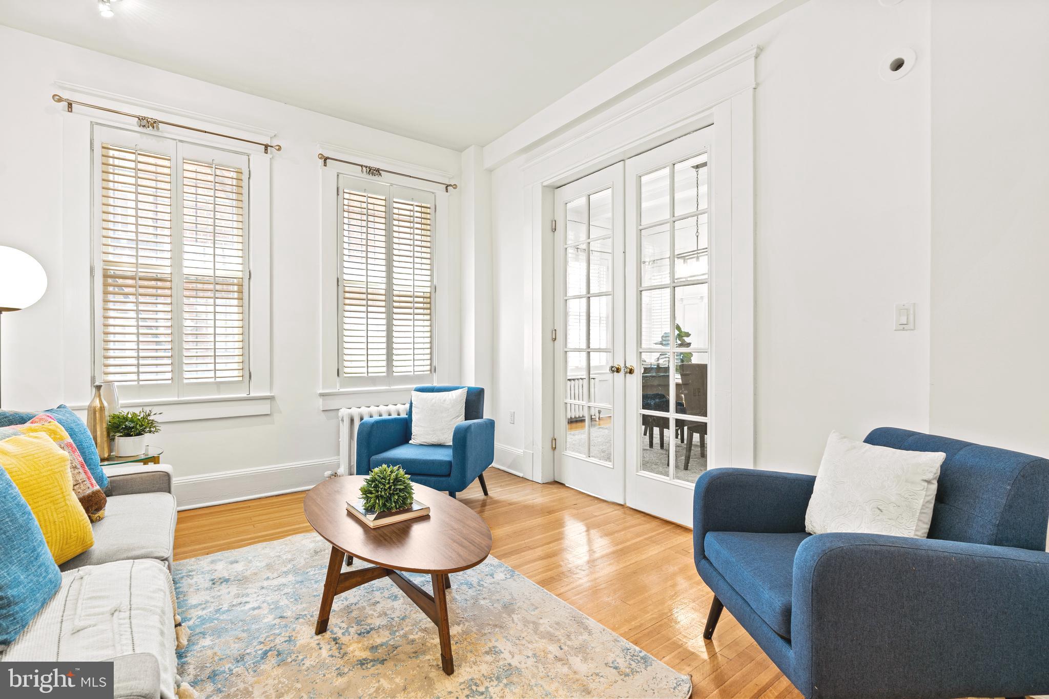 1736 Columbia Road Northwest, Unit 102 Washington, DC 20009 - Photo 8 of 37 a living room with furniture and a window
