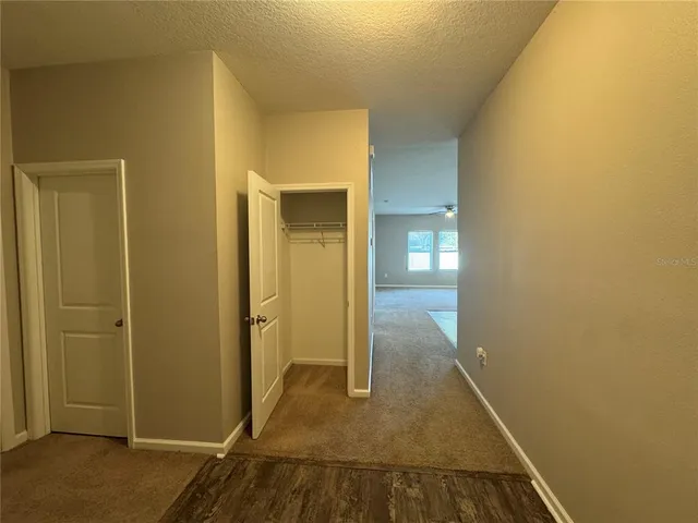 a view of kitchen with refrigerator and window