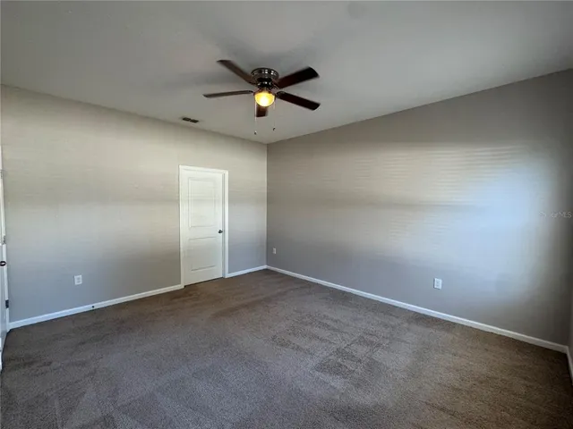 a bathroom with a granite countertop bathtub a sink and a mirror