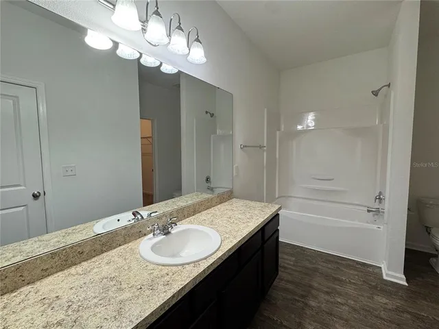a bathroom with a bathtub and a toilet