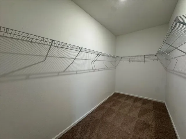 an empty room with closet and windows