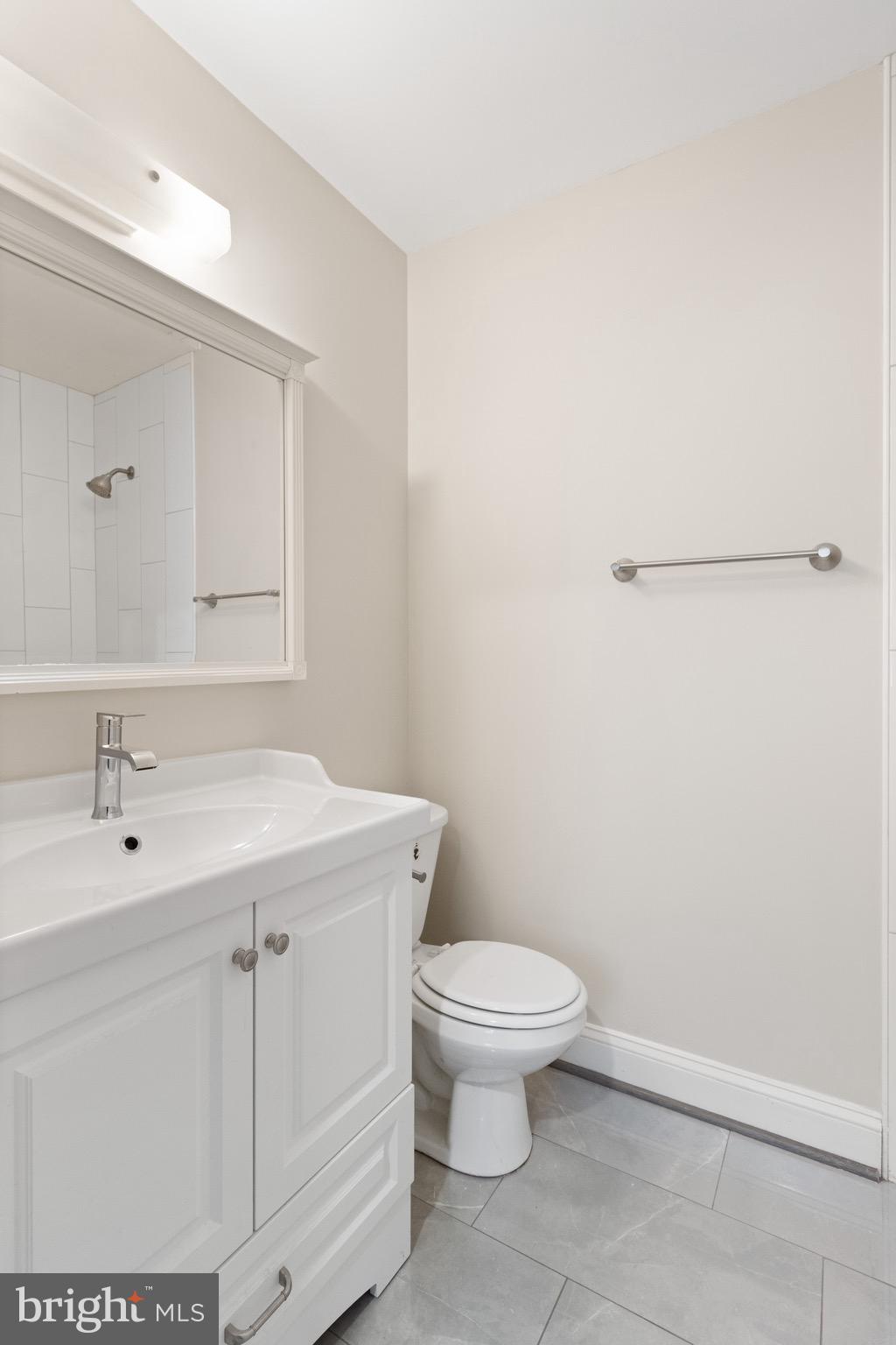 8581 Chester Grove Court Springfield, VA 22153 - Photo 31 of 38 a bathroom with a sink a toilet and mirror