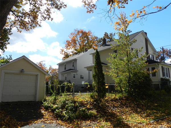85 Appleton Street Springfield, MA 01108 - Photo 21 of 22 a view of a house in front of a yard with plants and large trees