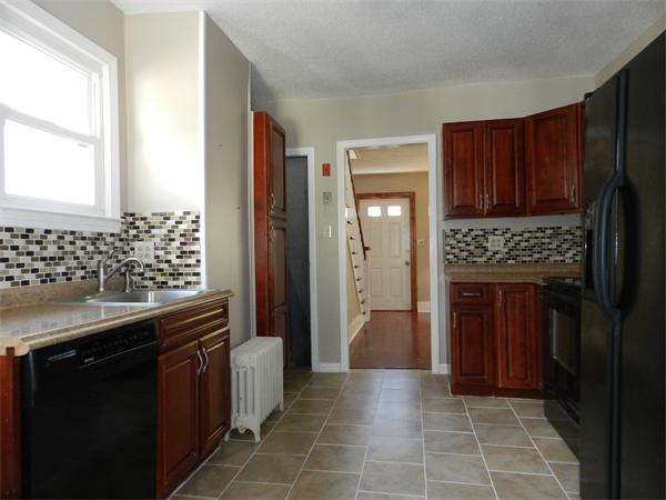 85 Appleton Street Springfield, MA 01108 - Photo 10 of 22 a kitchen with granite countertop a refrigerator and a stove