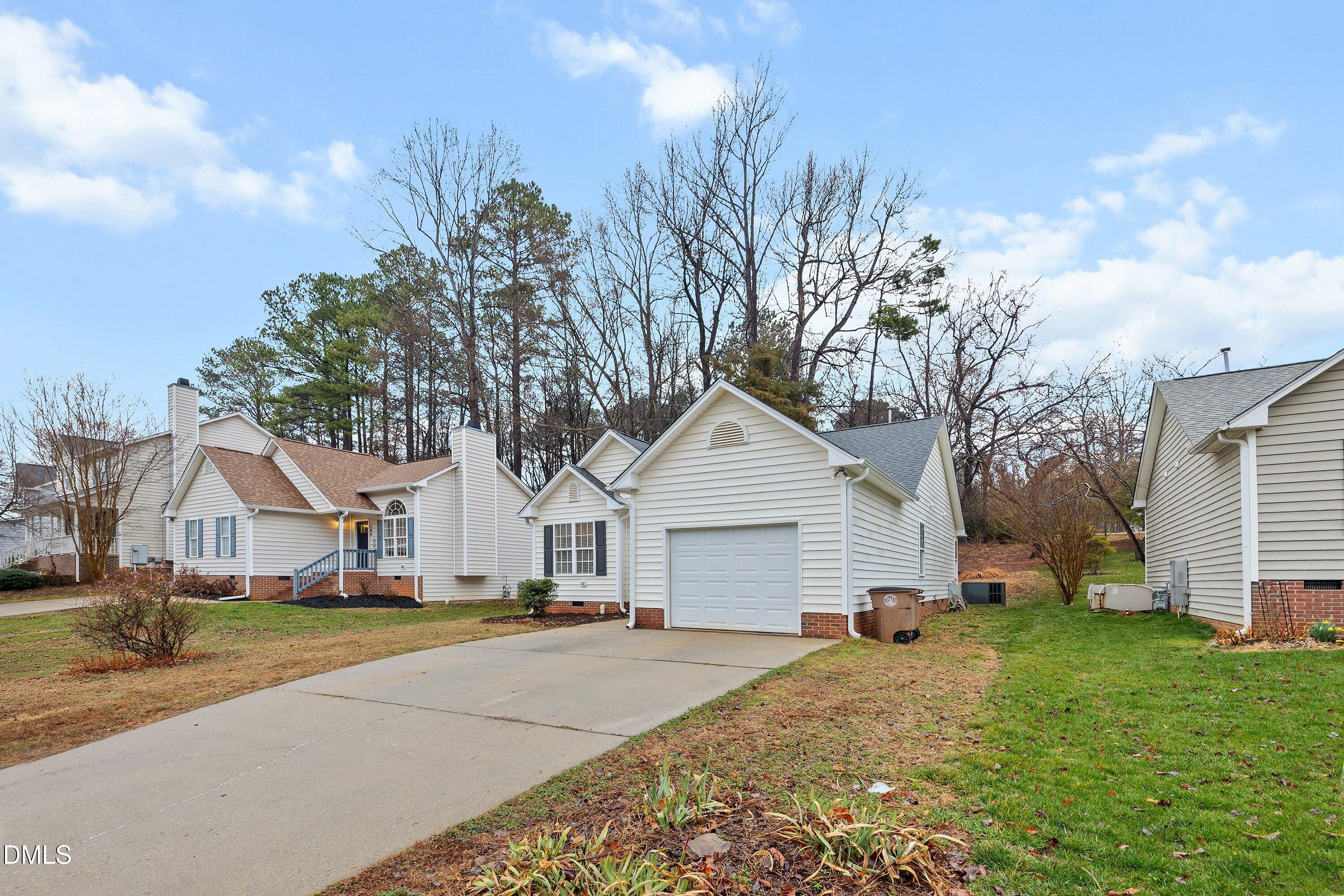 140 Melksham Road Wake Forest, NC 27587 - Photo 32 of 34 a view of a white house with a yard and large tree