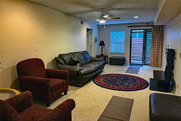 a living room with a couch and a chandelier