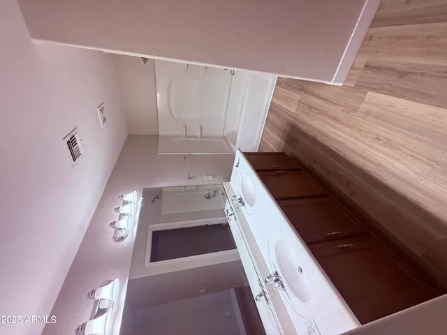 a view of entryway with furniture and wooden floor