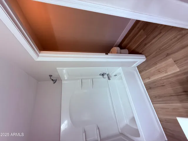 a view of a hallway to a livingroom with furniture