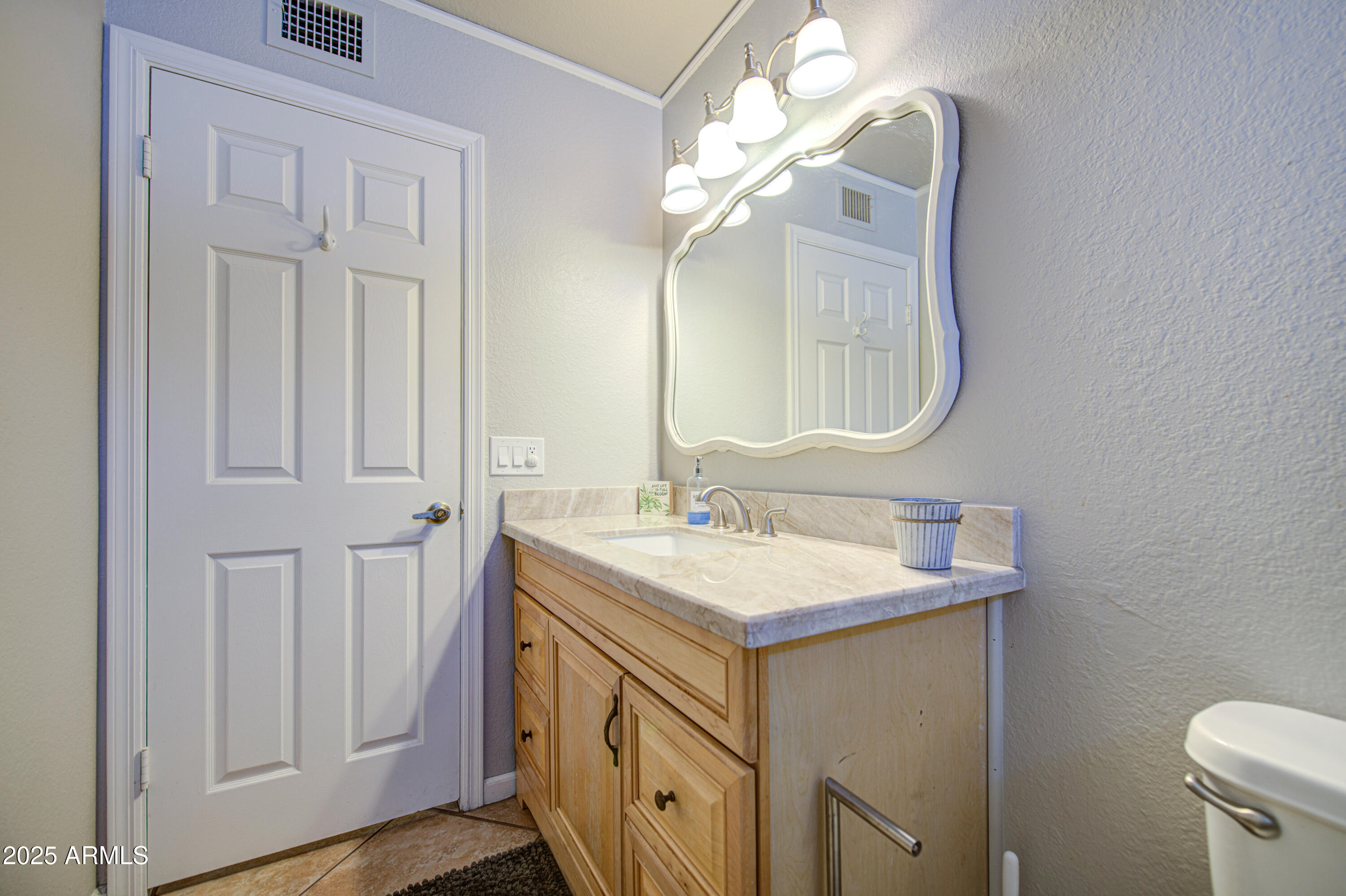 907 West Redfield Road Tempe, AZ 85283 - Photo 38 of 53 a bathroom with a sink a mirror and a toilet