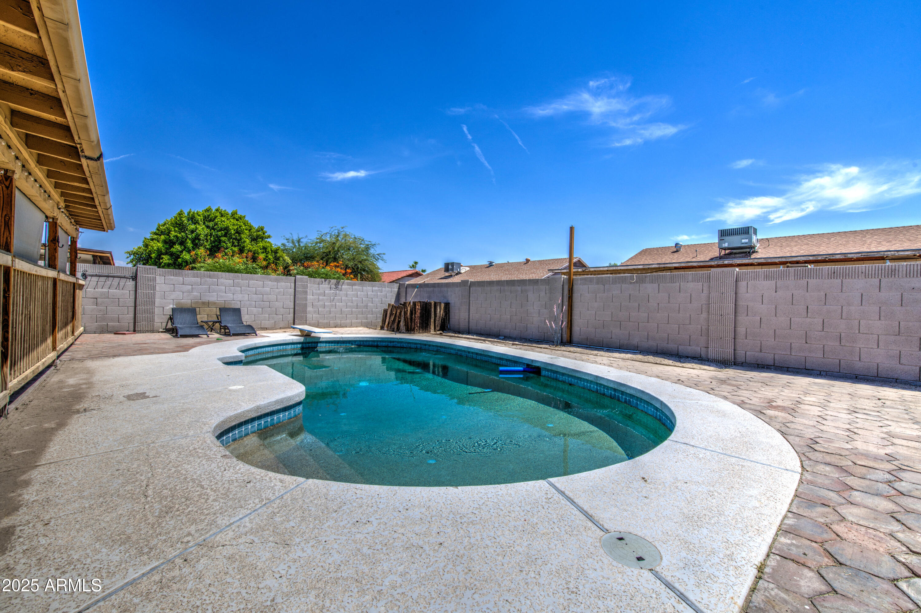 907 West Redfield Road Tempe, AZ 85283 - Photo 45 of 53 a view of a swimming pool with a yard