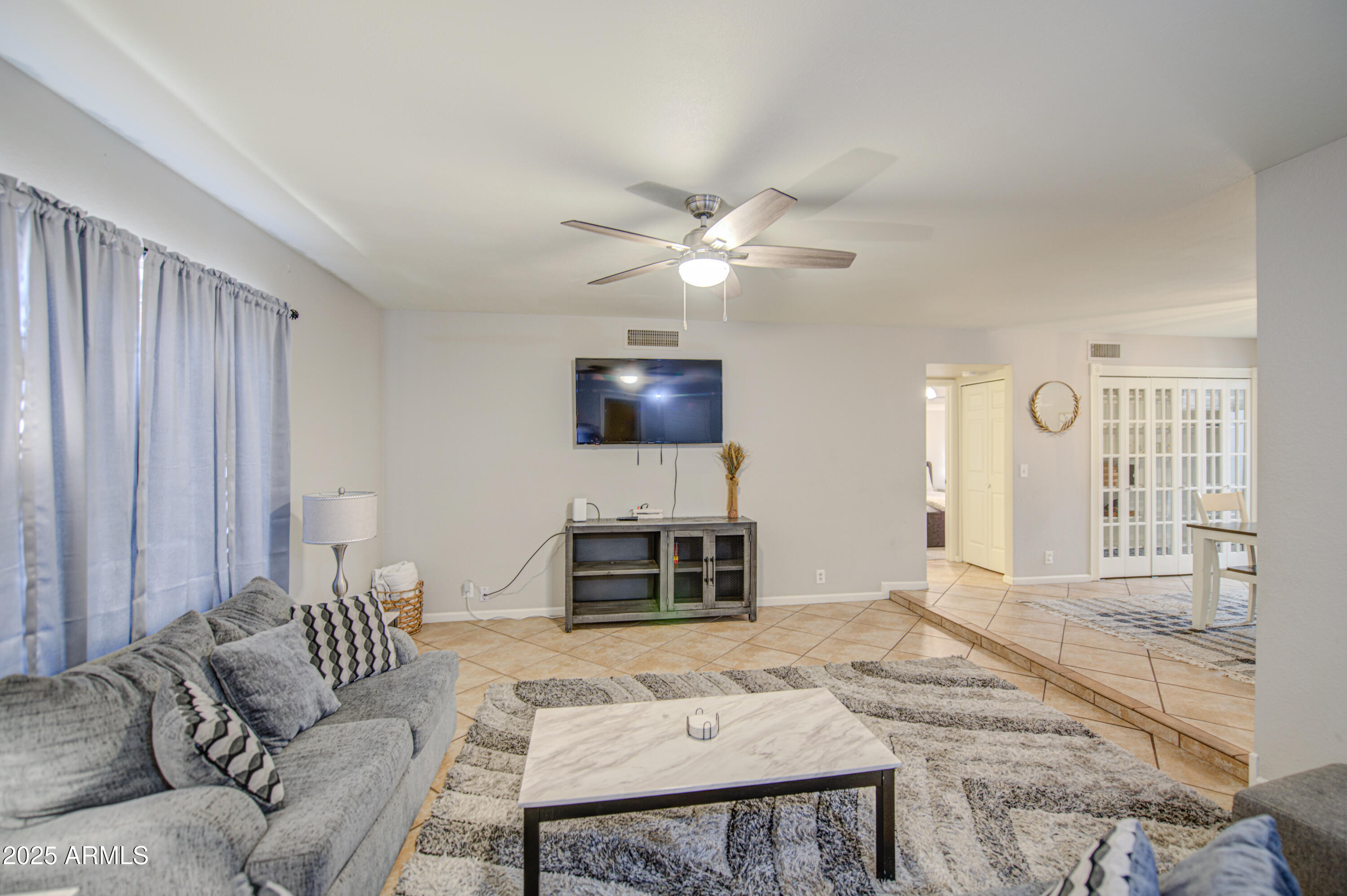 907 West Redfield Road Tempe, AZ 85283 - Photo 5 of 53 a living room with furniture and a flat screen tv
