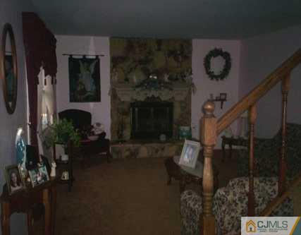 36 Raleigh Road Kendall Park, NJ 08824 - Photo 3 of 6 a living room with furniture and a fireplace