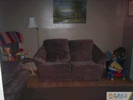 36 Raleigh Road Kendall Park, NJ 08824 - Photo 5 of 6 a living room with furniture and a lamp