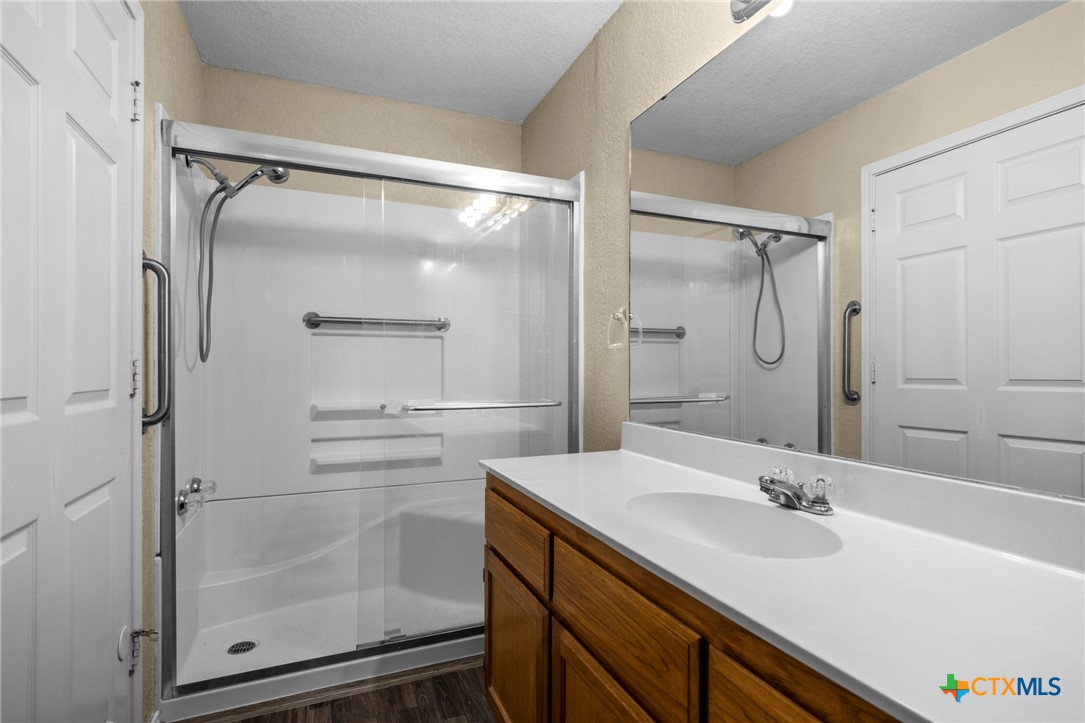 1012 Cherokee Trail Kempner, TX 76539 - Photo 11 of 27 a bathroom with a shower sink vanity and mirror
