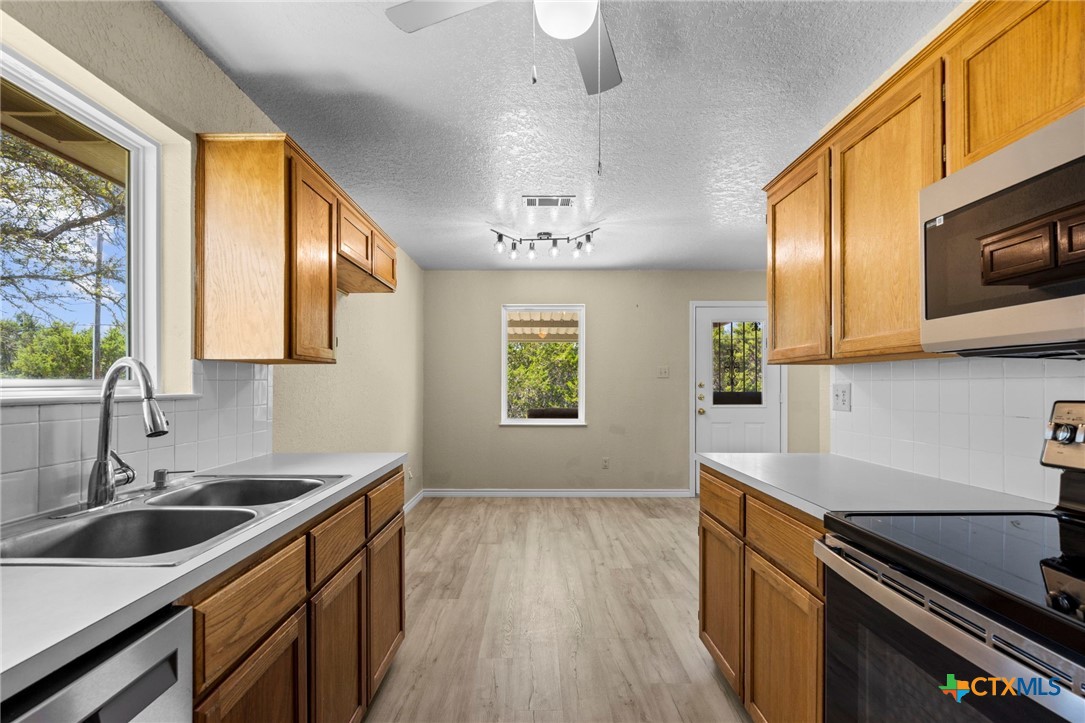 1012 Cherokee Trail Kempner, TX 76539 - Photo 21 of 27 a kitchen that has a sink a stove and wooden floor