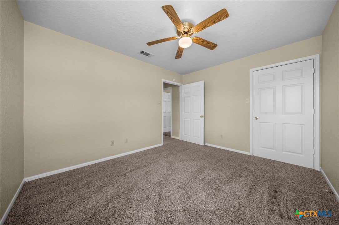 1012 Cherokee Trail Kempner, TX 76539 - Photo 26 of 27 an empty room with a ceiling fan and painted walls