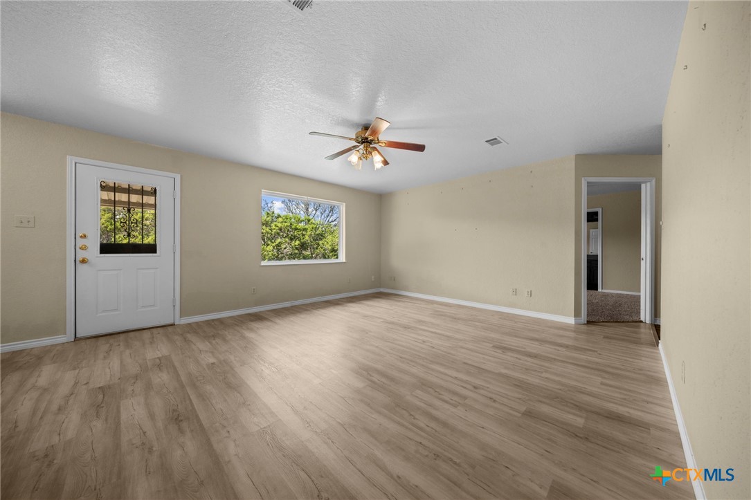 1012 Cherokee Trail Kempner, TX 76539 - Photo 27 of 27 an empty room with windows and a ceiling fan