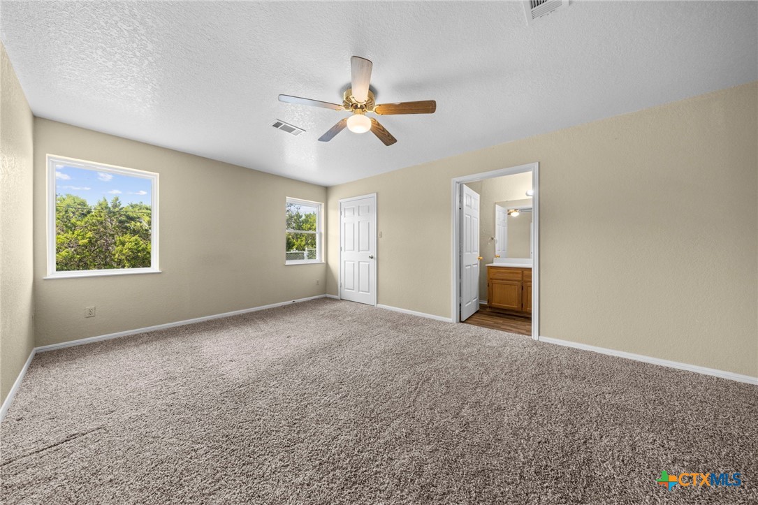 1012 Cherokee Trail Kempner, TX 76539 - Photo 6 of 27 an empty room with windows and ceiling fan