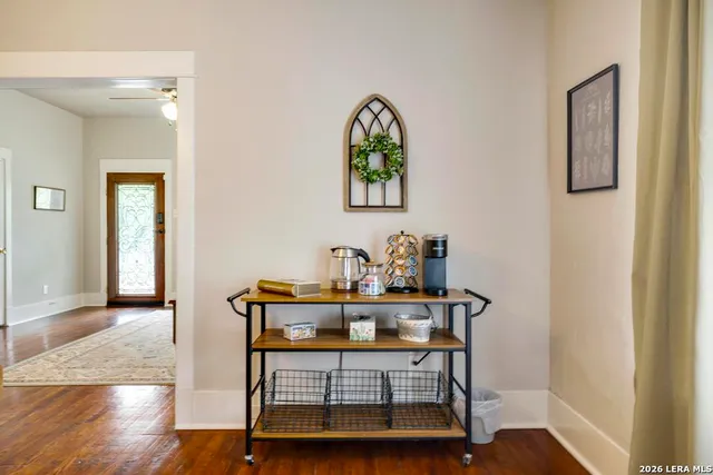 a view of a workspace with furniture and wooden floor