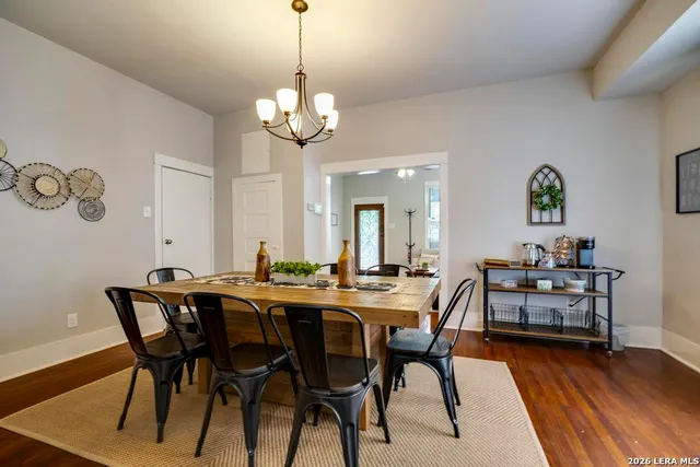 a view of a dining room with furniture wooden floor and chandelier