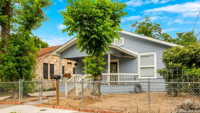 a view of house with a yard and sitting area