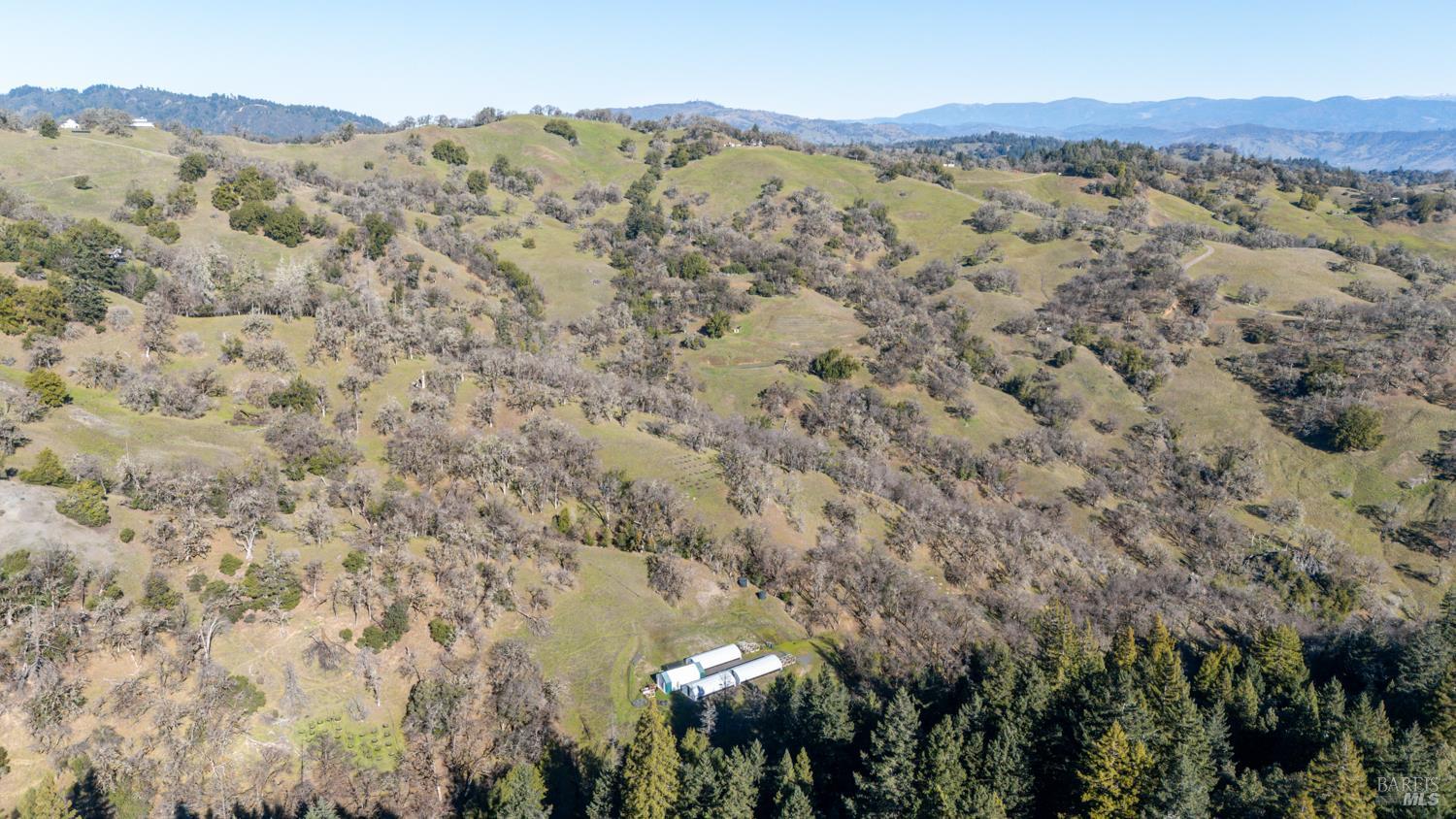 5400 Orr Springs Road Ukiah, CA 95482 - Photo 26 of 29 a view of a dry yard with mountains in the background