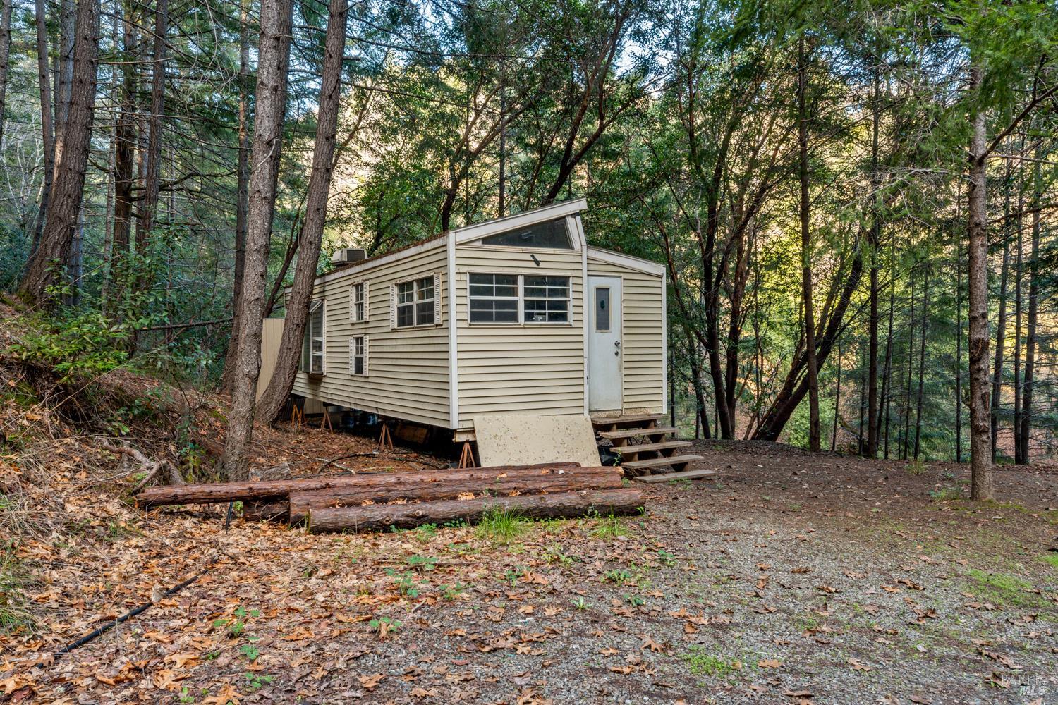 5400 Orr Springs Road Ukiah, CA 95482 - Photo 5 of 29 a view of a house with a yard and trees