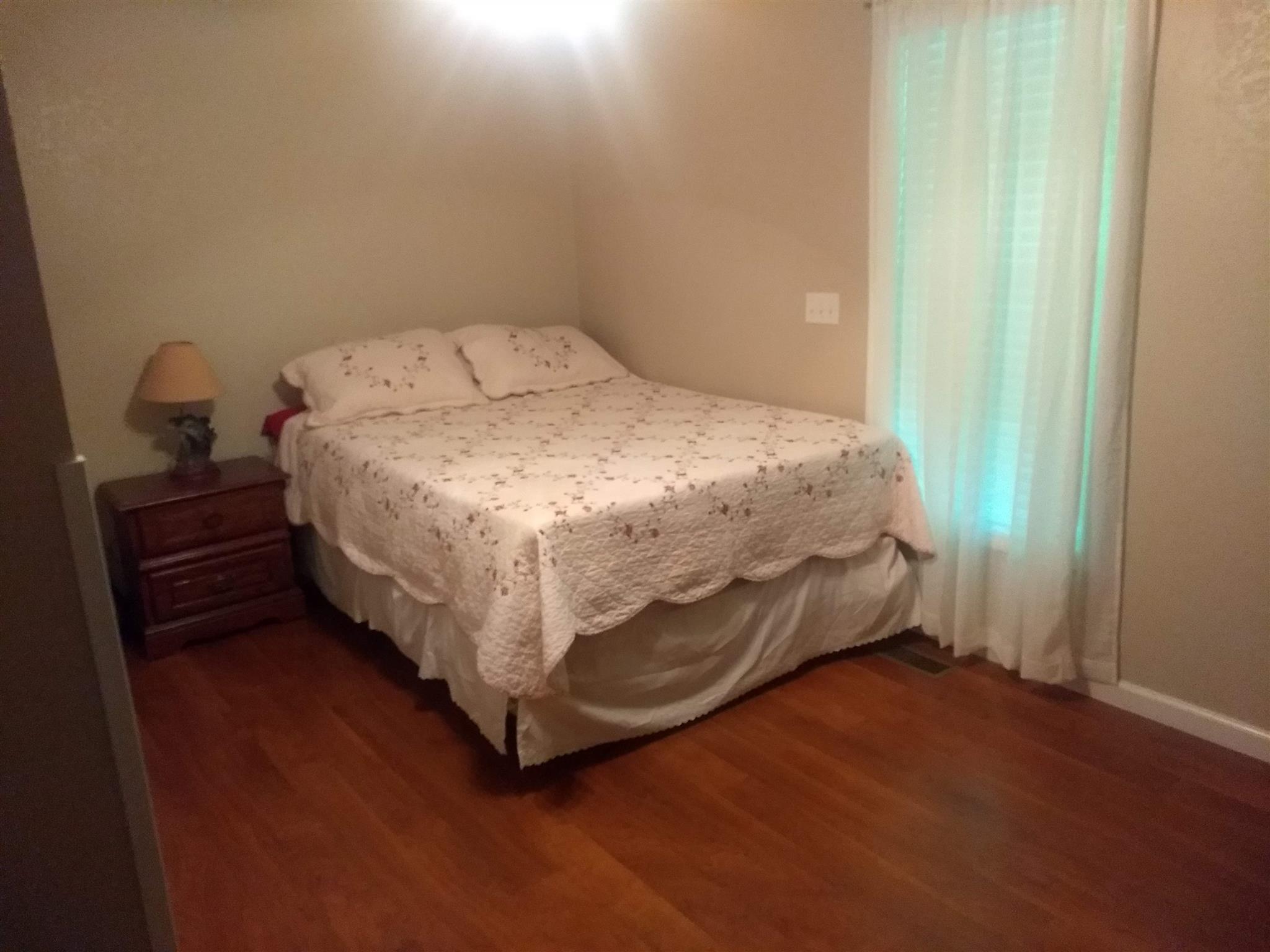 1154 Loftin Road Columbia, TN 38401 - Photo 6 of 8 a bed sitting in a bedroom next to a window