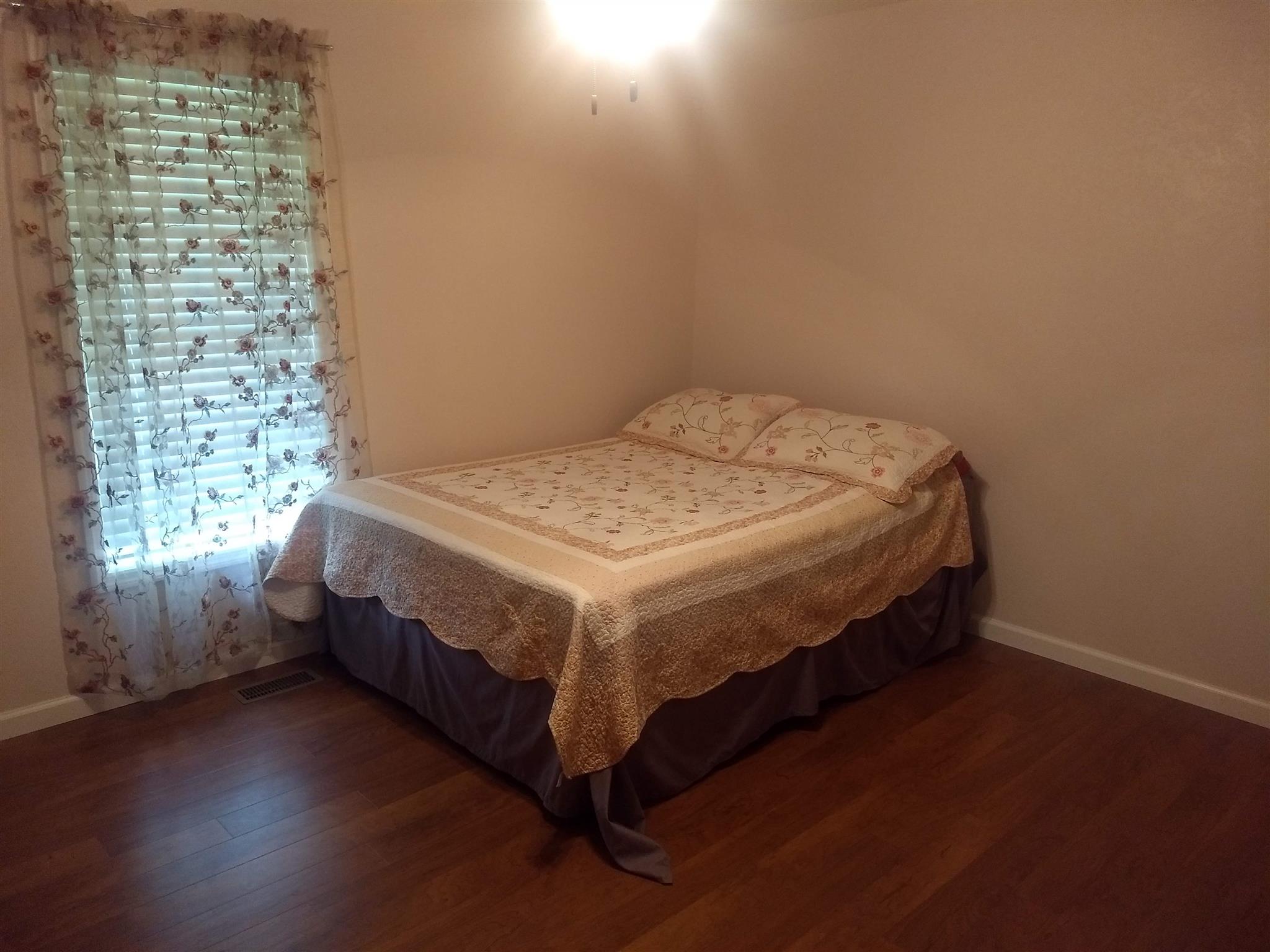 1154 Loftin Road Columbia, TN 38401 - Photo 7 of 8 a bed sitting in a bedroom next to a window