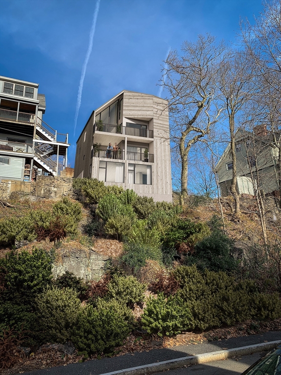 63 Beech Glen Street Boston, MA 02119 - Photo 2 of 9 a front view of a house with a yard