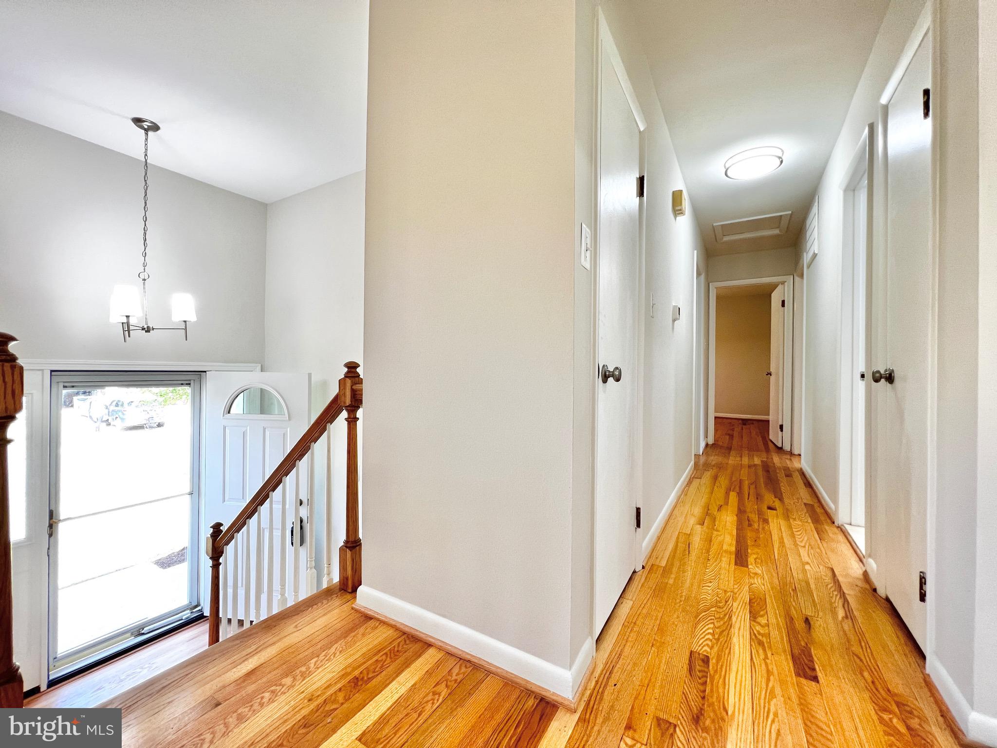 11218 Keystone Avenue Clinton, MD 20735 - Photo 17 of 53 a view of a hallway with wooden floor and staircase