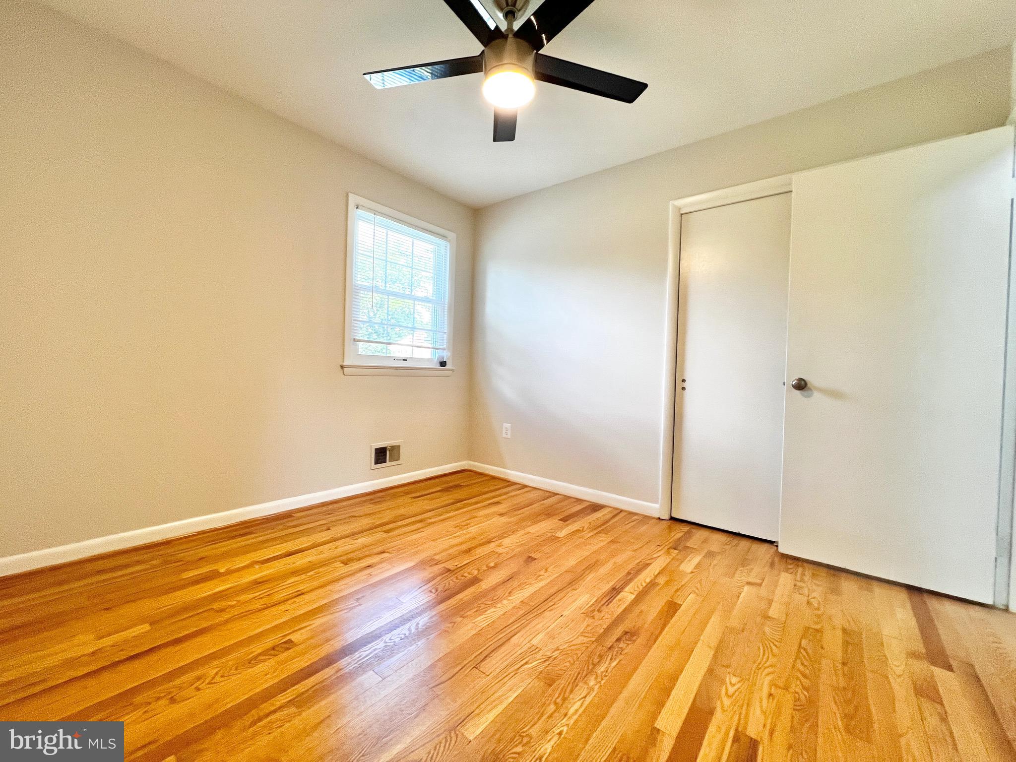11218 Keystone Avenue Clinton, MD 20735 - Photo 23 of 53 a view of an empty room with wooden floor and a window