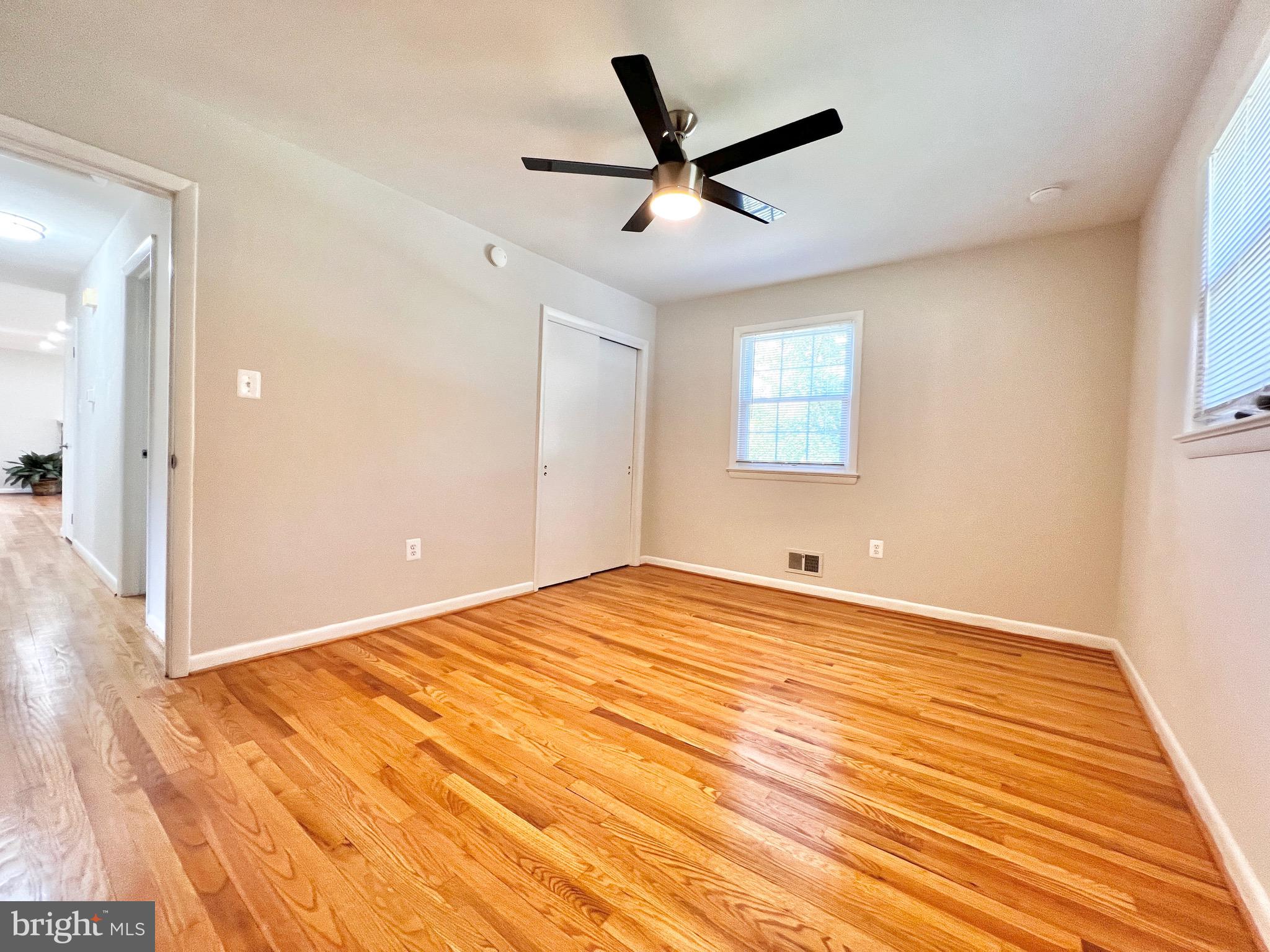 11218 Keystone Avenue Clinton, MD 20735 - Photo 24 of 53 a view of a big room with wooden floor and windows