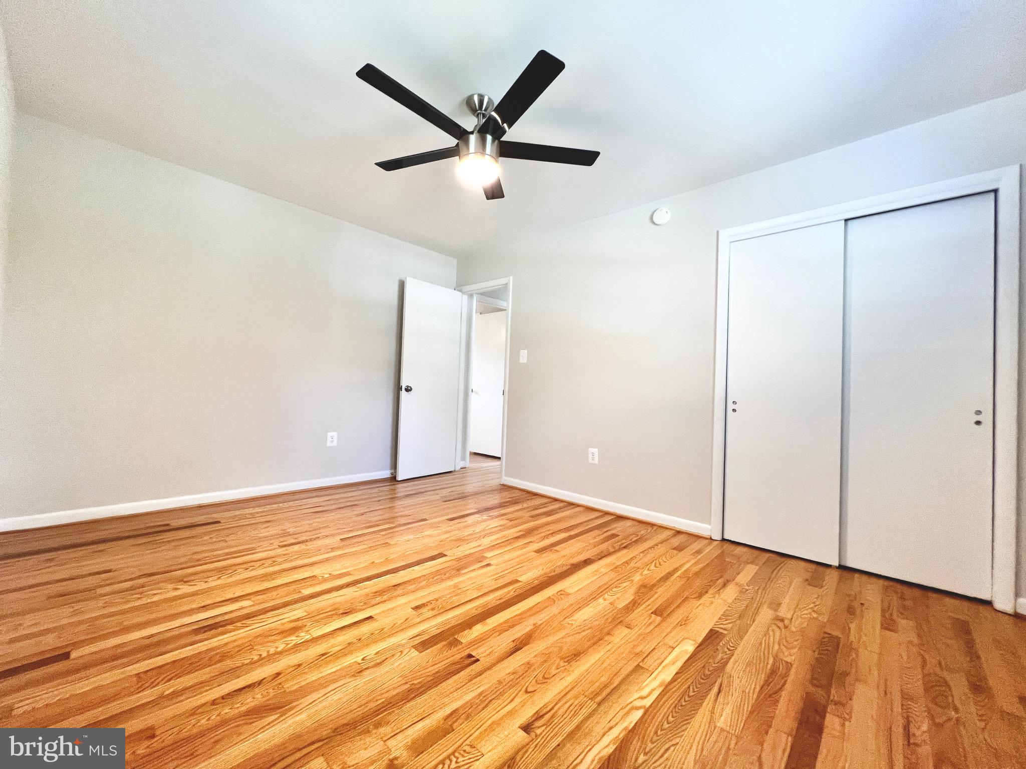 11218 Keystone Avenue Clinton, MD 20735 - Photo 26 of 53 an empty room with wooden floor and a ceiling fan