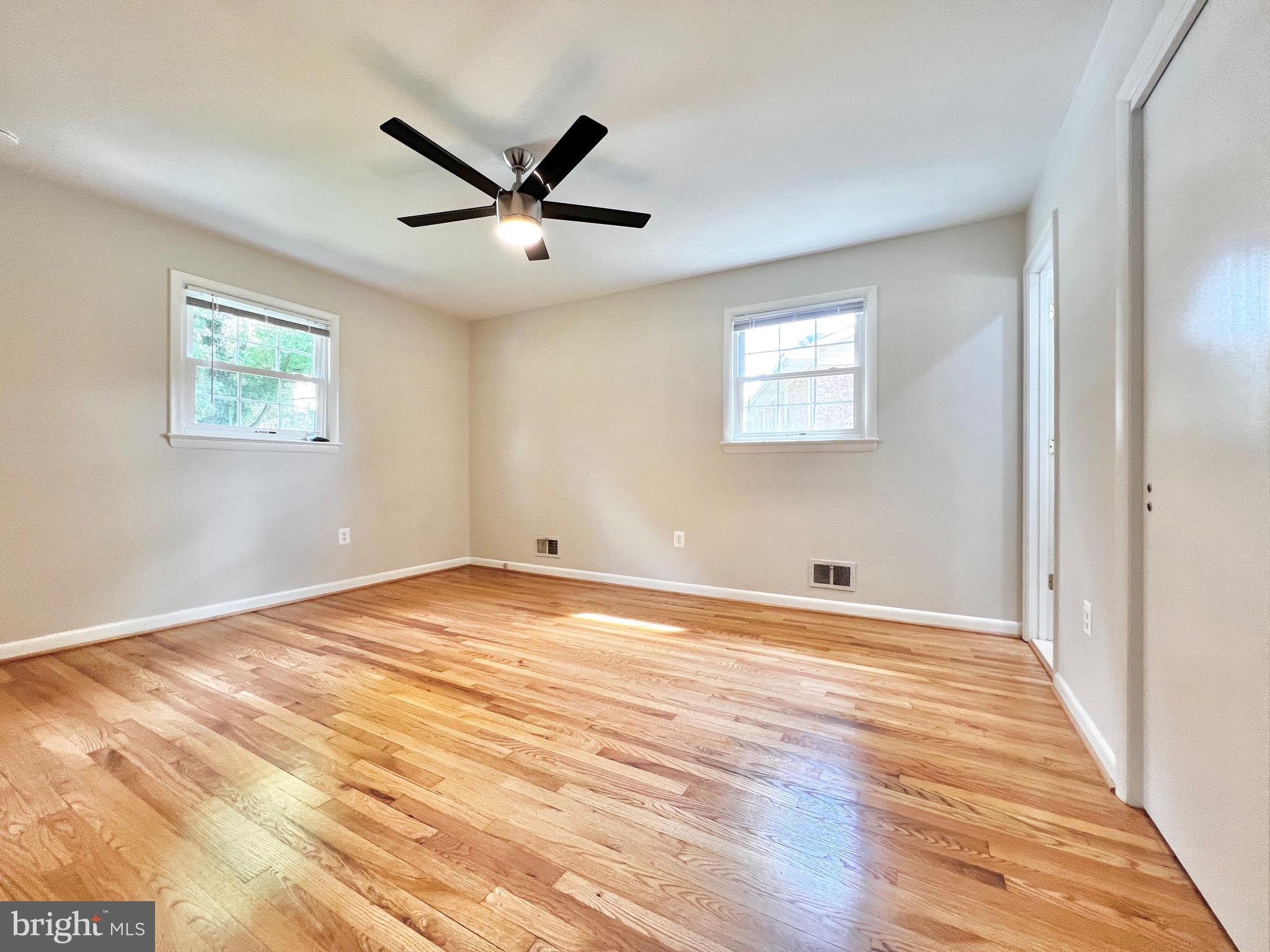 11218 Keystone Avenue Clinton, MD 20735 - Photo 27 of 53 a view of a big room with wooden floor and windows