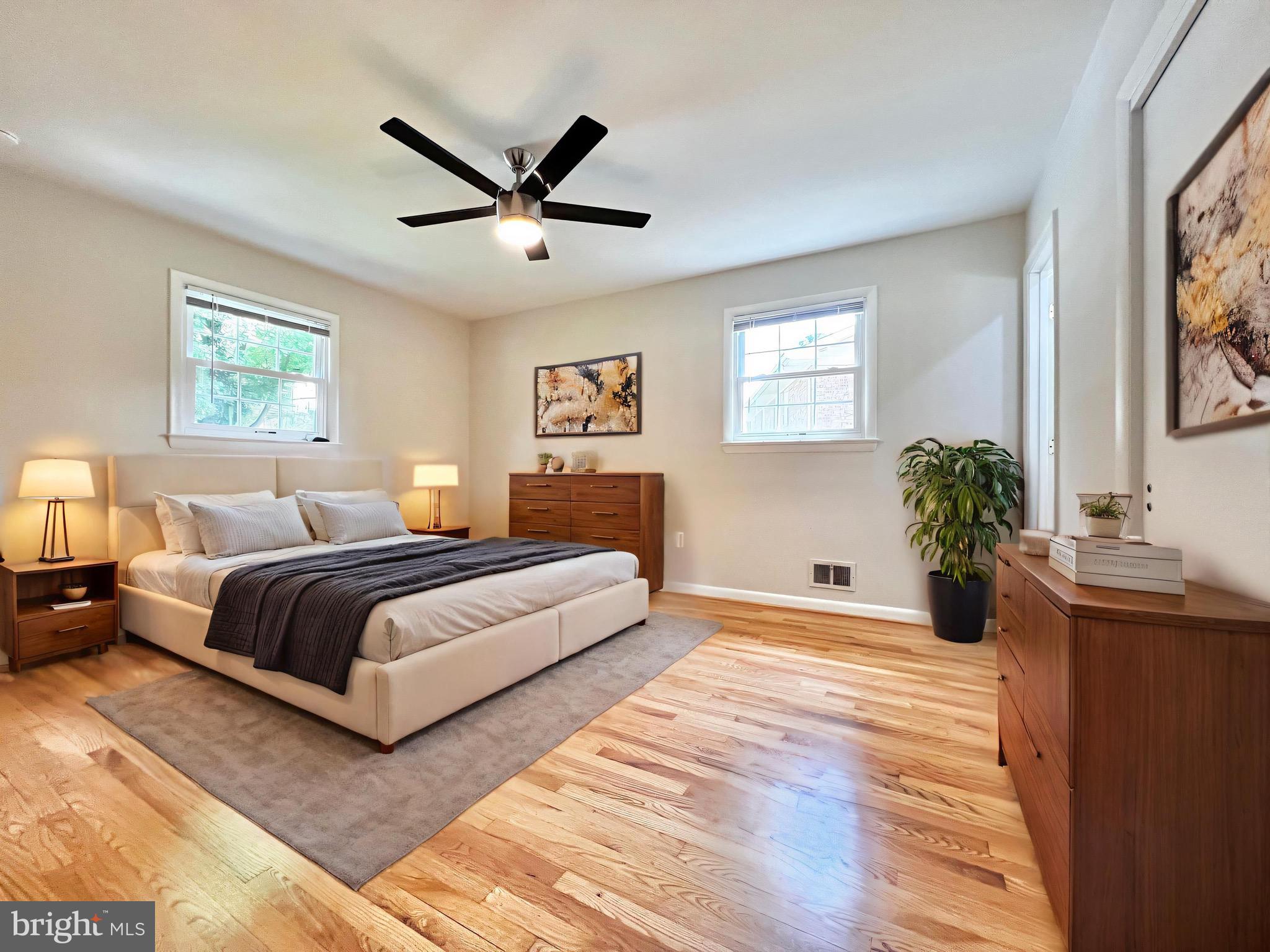11218 Keystone Avenue Clinton, MD 20735 - Photo 28 of 53 a bedroom with a large bed and a chandelier
