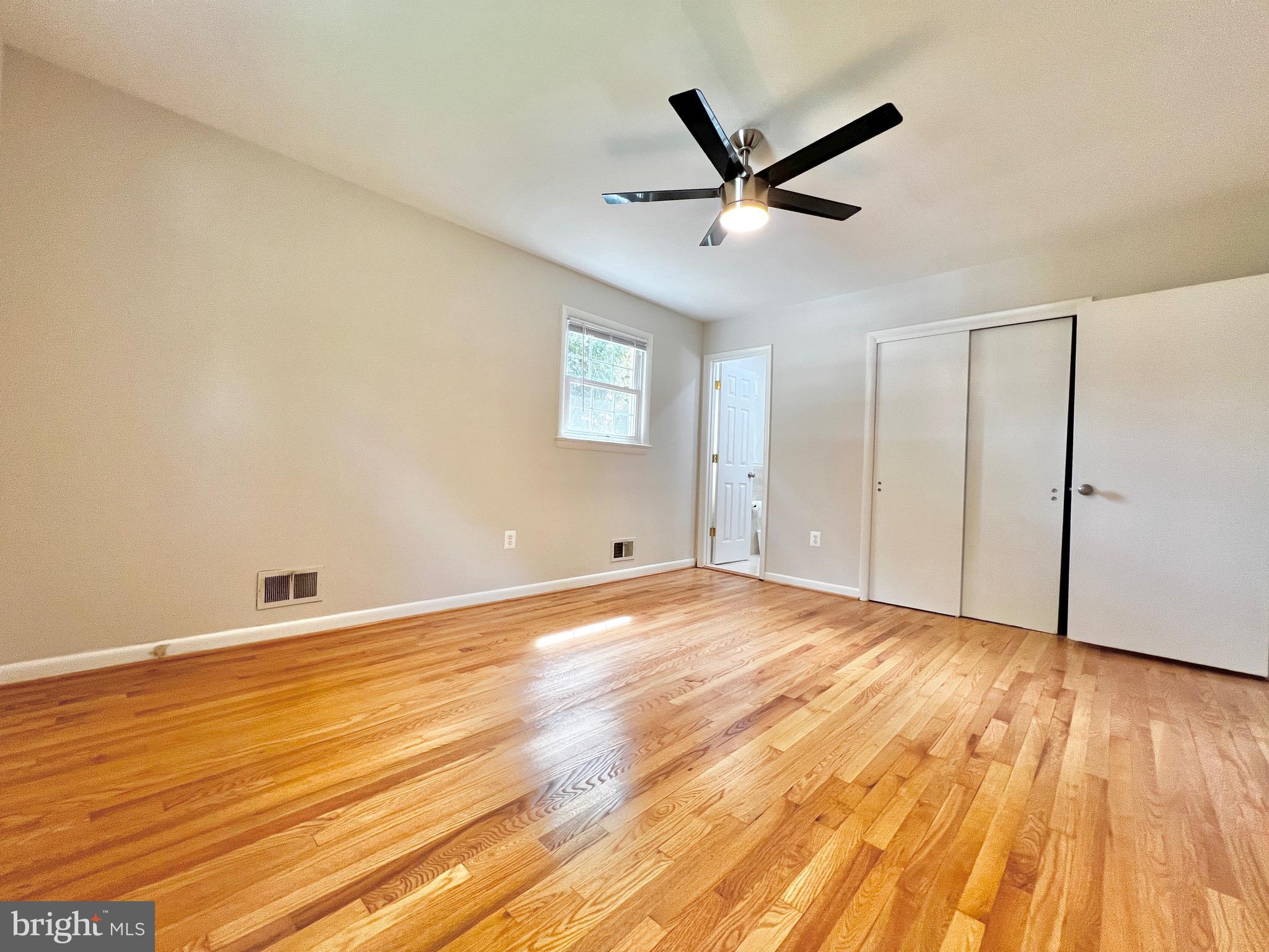 11218 Keystone Avenue Clinton, MD 20735 - Photo 29 of 53 a view of a livingroom with wooden floor and a ceiling fan