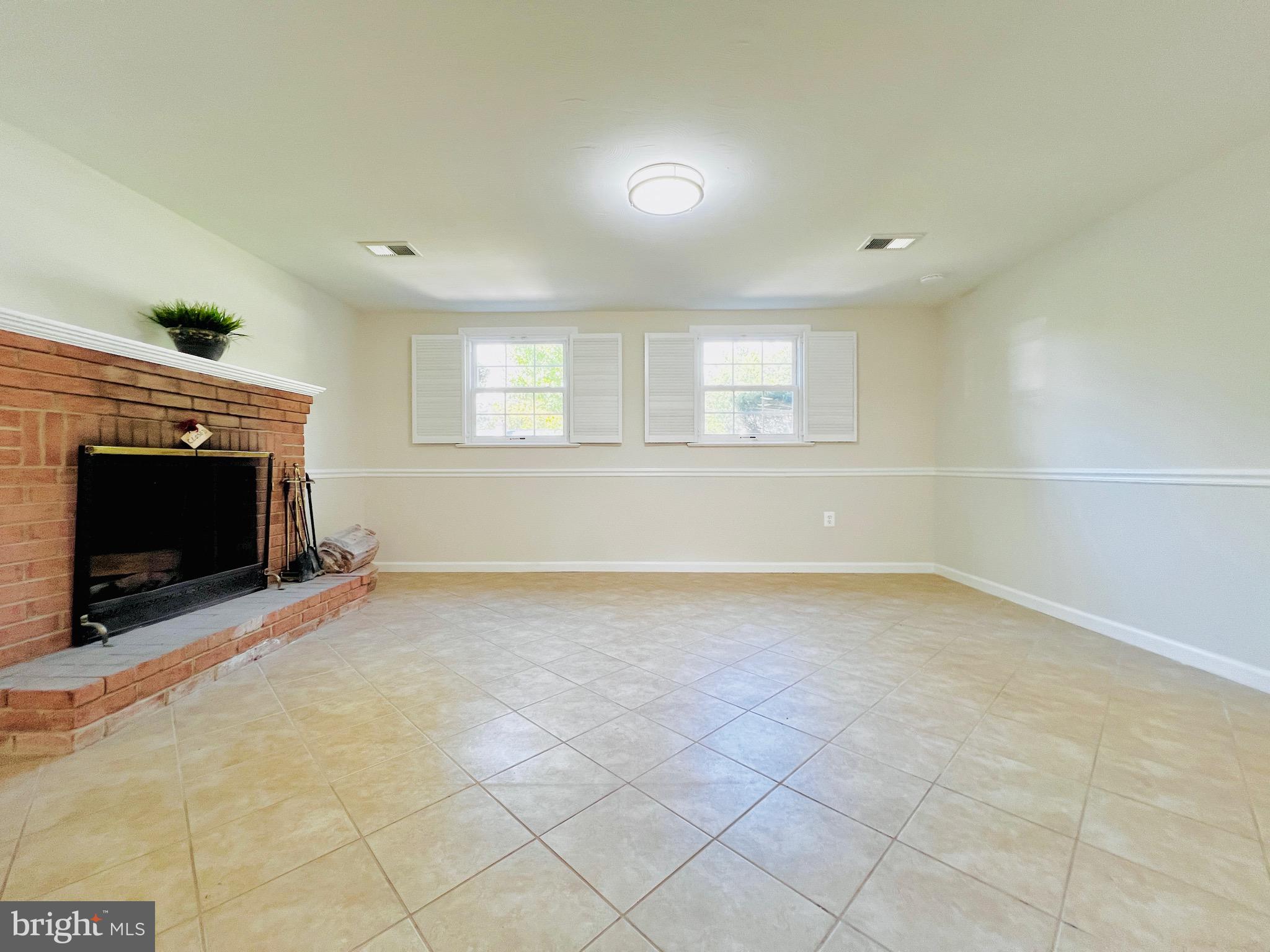 11218 Keystone Avenue Clinton, MD 20735 - Photo 33 of 53 an empty room with windows and fireplace