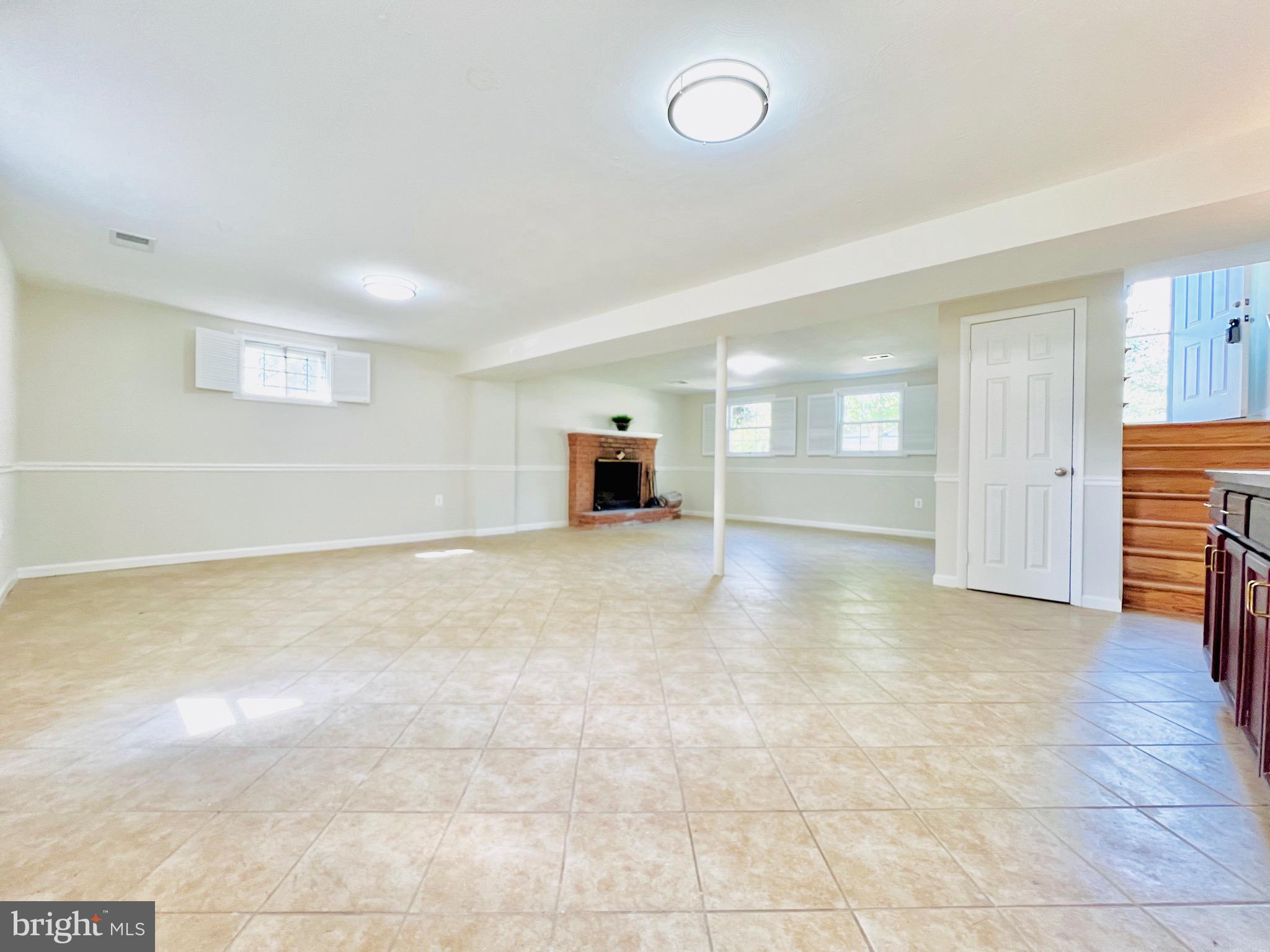 11218 Keystone Avenue Clinton, MD 20735 - Photo 35 of 53 an empty room with fireplace and windows