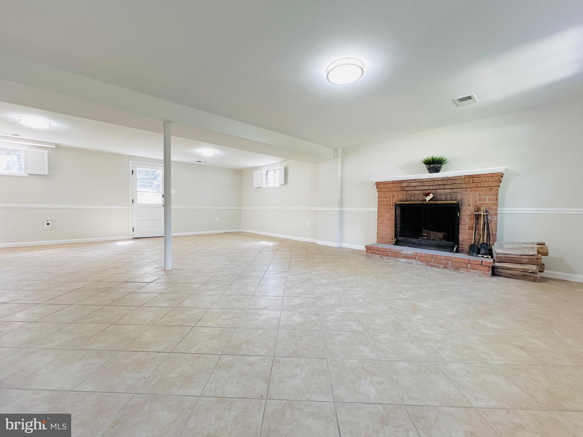 11218 Keystone Avenue Clinton, MD 20735 - Photo 36 of 53 a view of a room with an empty space and a fireplace