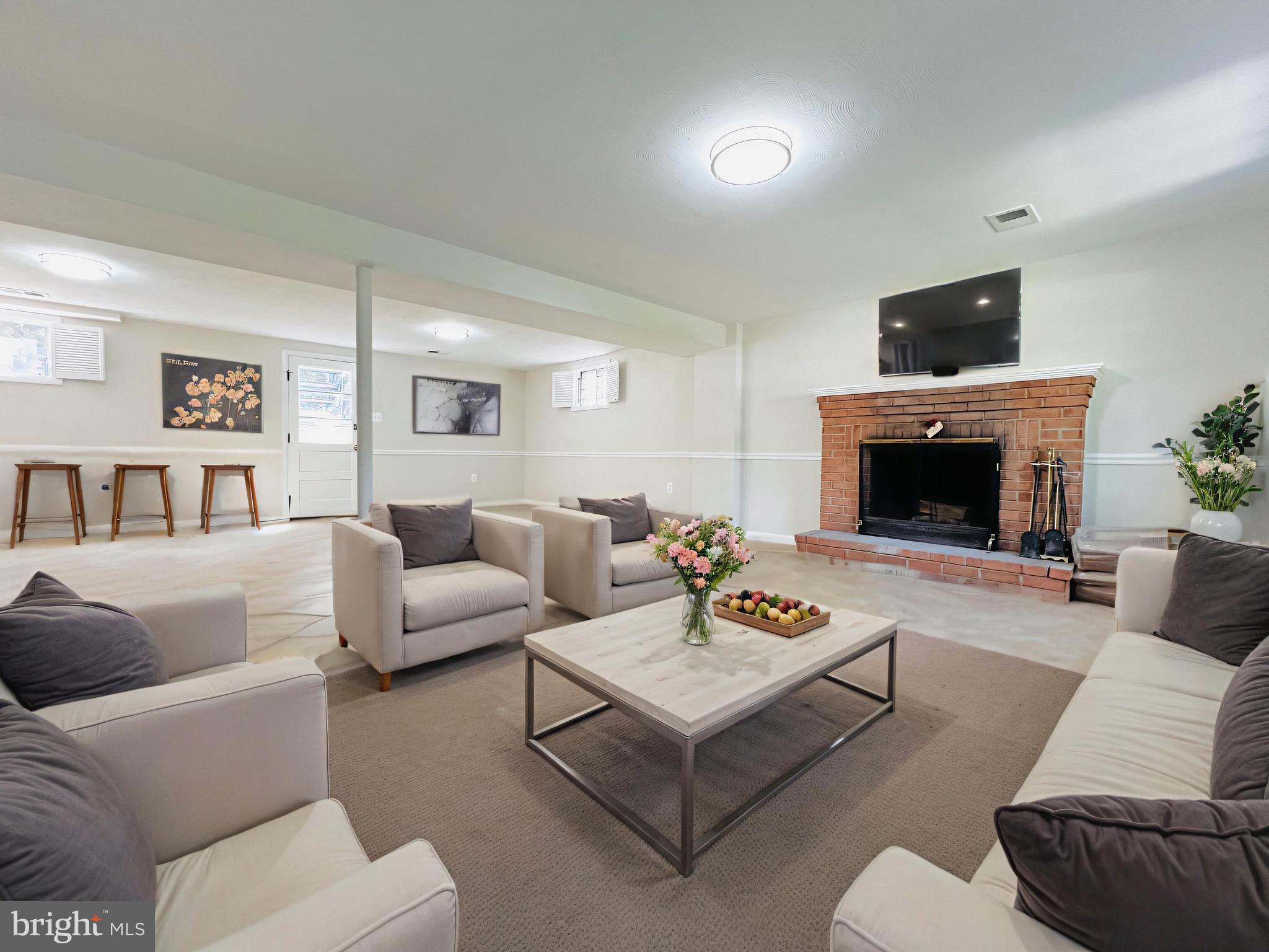 11218 Keystone Avenue Clinton, MD 20735 - Photo 37 of 53 a living room with furniture and a fireplace