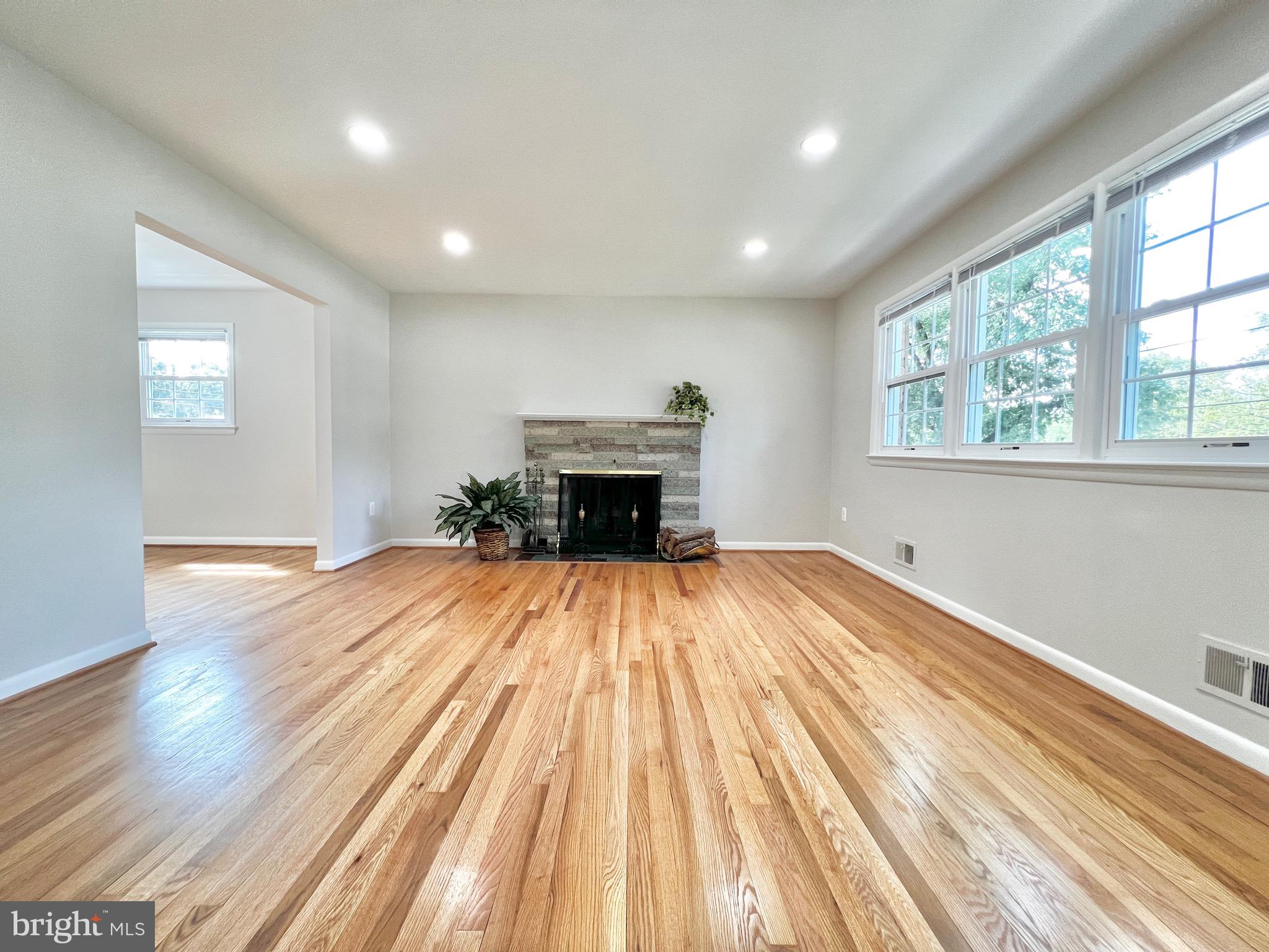 11218 Keystone Avenue Clinton, MD 20735 - Photo 4 of 53 an empty room with wooden floor and windows