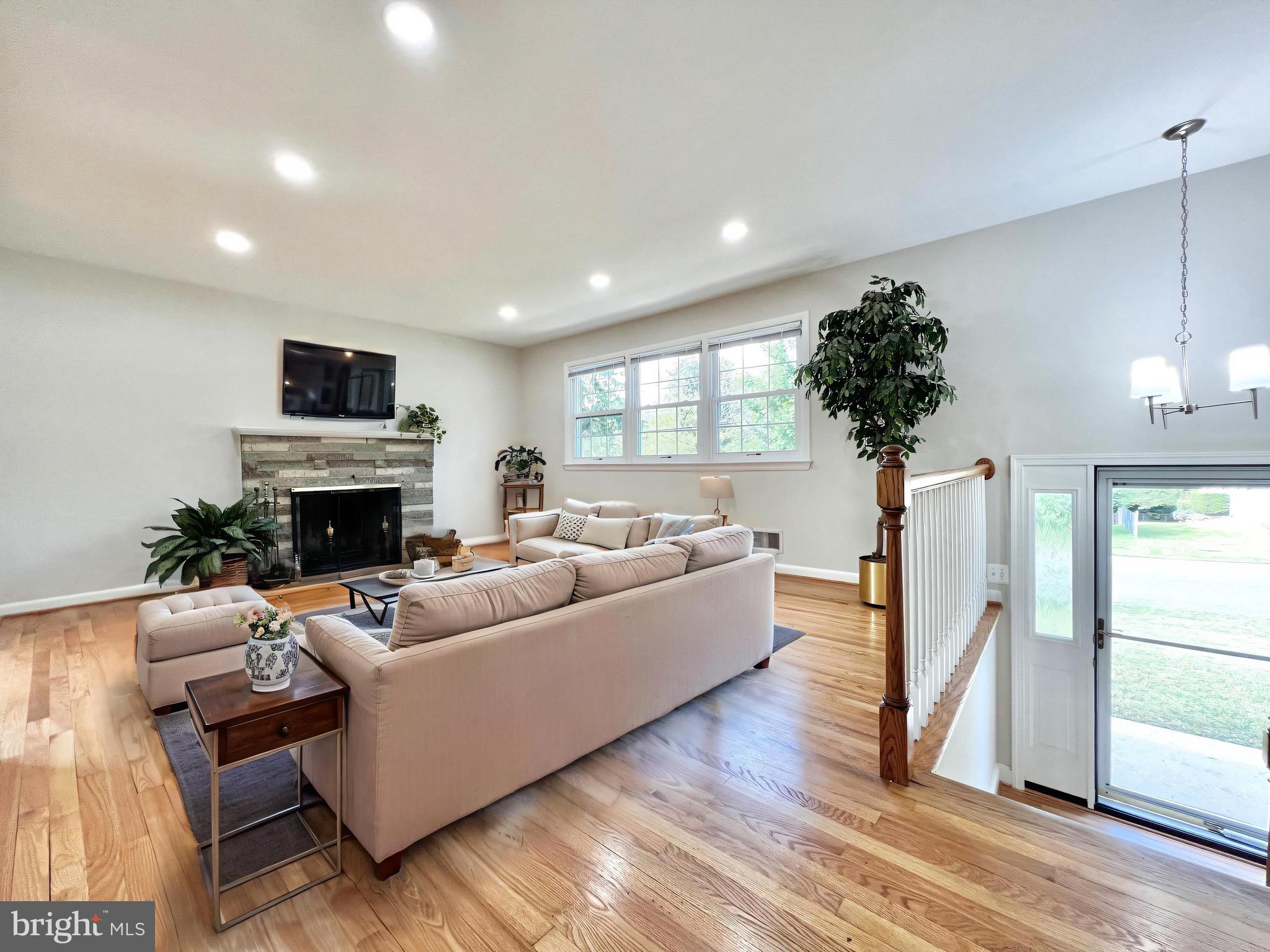 11218 Keystone Avenue Clinton, MD 20735 - Photo 6 of 53 a living room with furniture a fireplace and a flat screen tv