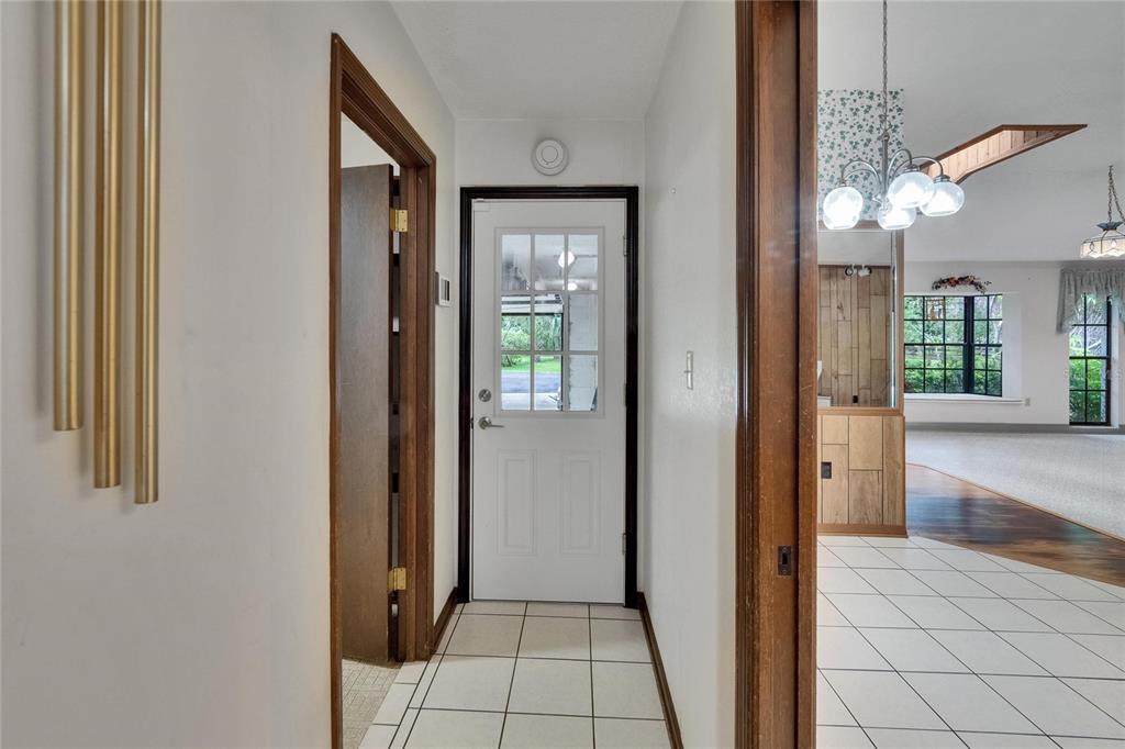 3102 East Trapnell Road Plant City, FL 33566 - Photo 54 of 100 a view of a hallway with wooden floor and a living room