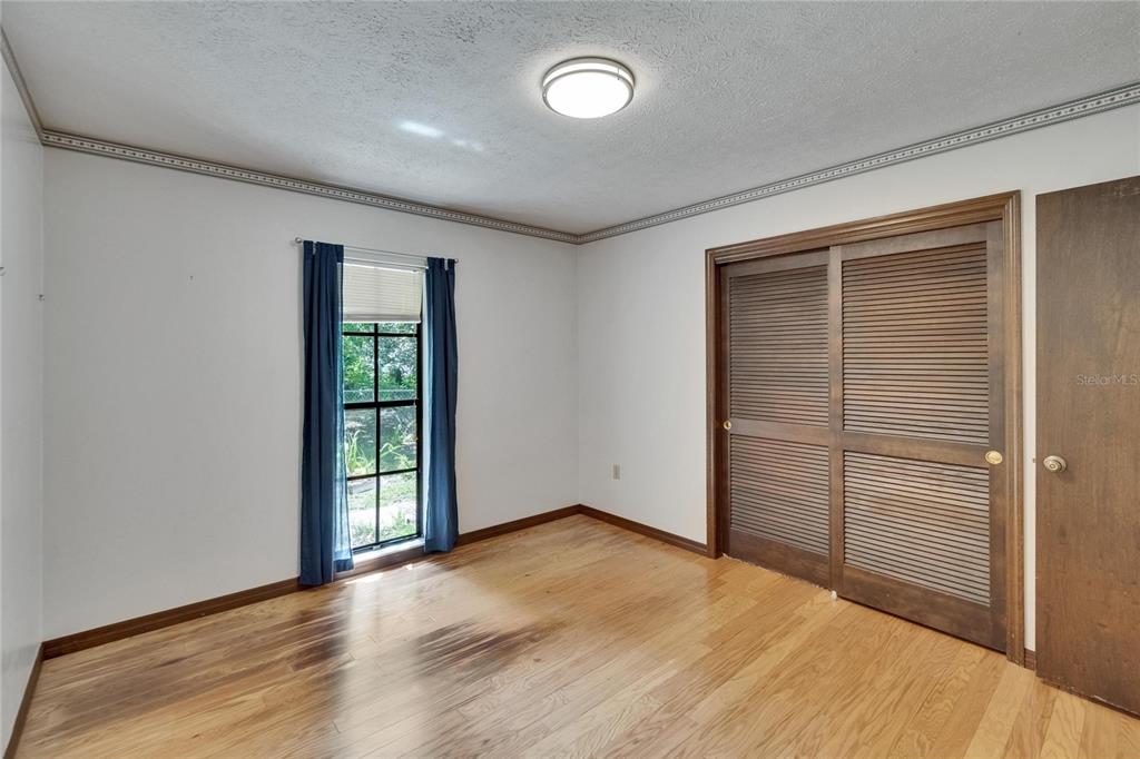 3102 East Trapnell Road Plant City, FL 33566 - Photo 84 of 100 an empty room with wooden floor and windows
